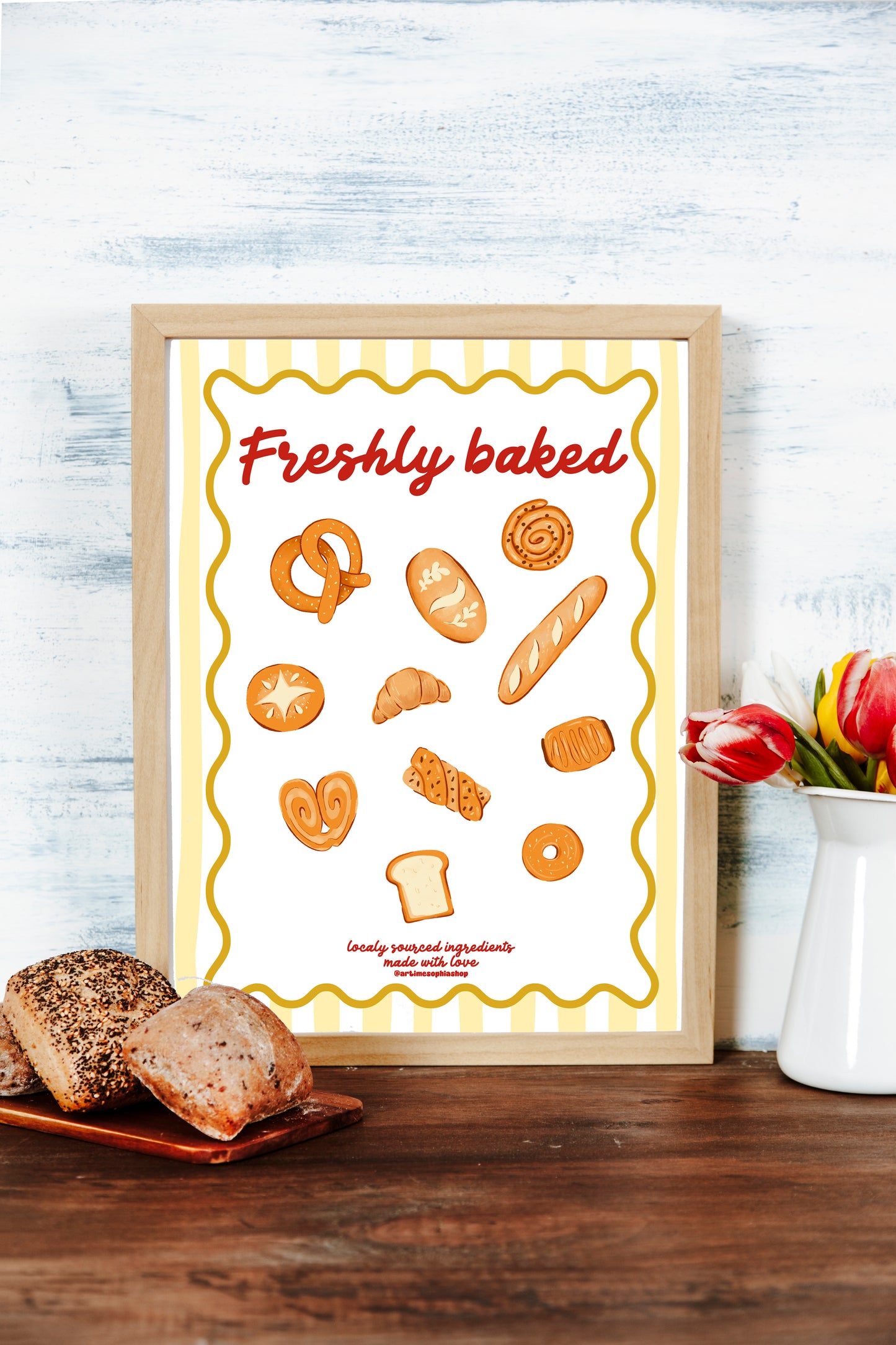 Illustrated bakery-themed art print featuring hand-drawn breads and pastries with the phrase "Freshly Baked" on a yellow striped background.