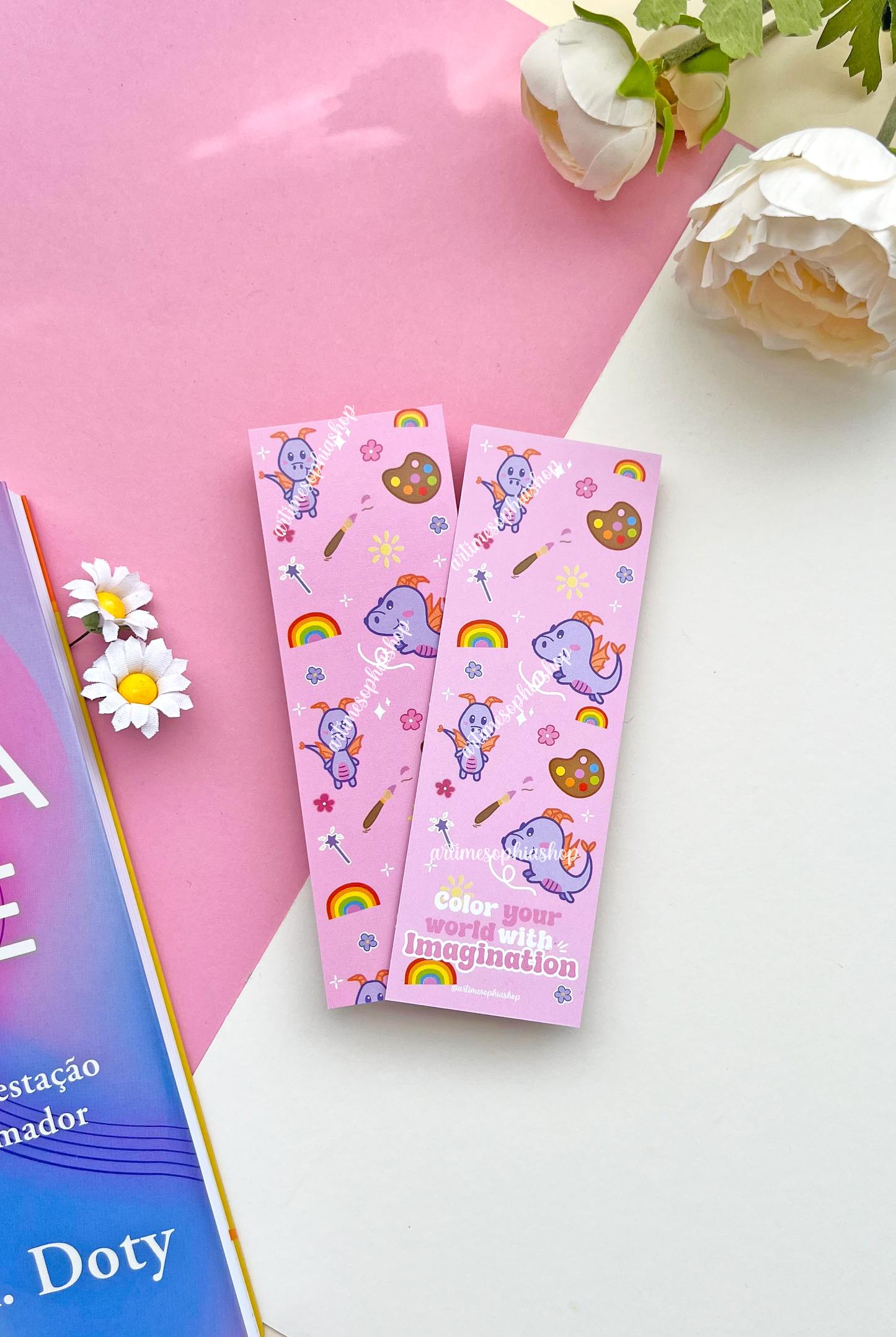 Double-sided lilac and pink bookmark featuring Figment surrounded by flowers, rainbow colors, and art supplies, with the phrase “Color your world with imagination” on the back.