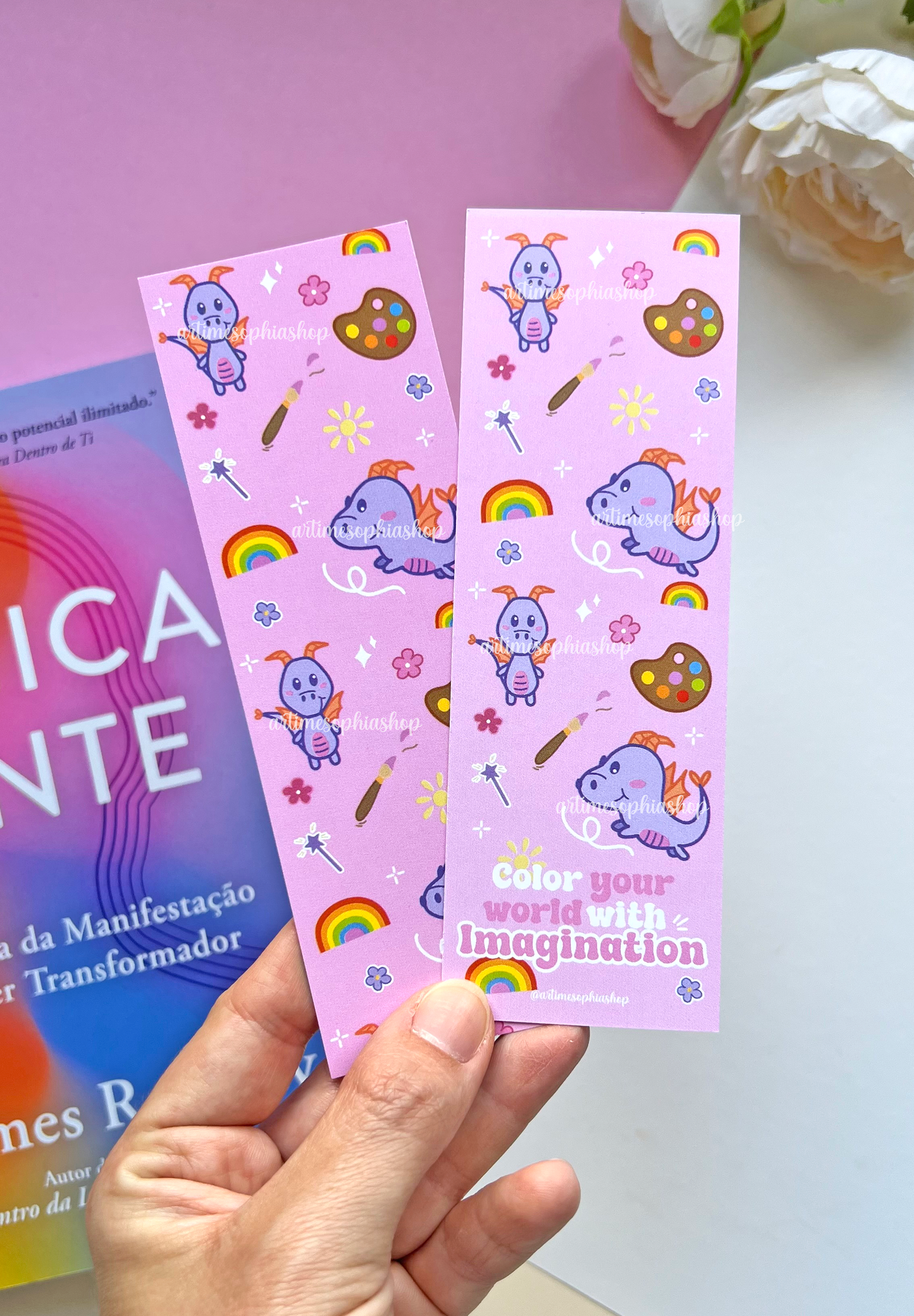 Double-sided lilac and pink bookmark featuring Figment surrounded by flowers, rainbow colors, and art supplies, with the phrase “Color your world with imagination” on the back.