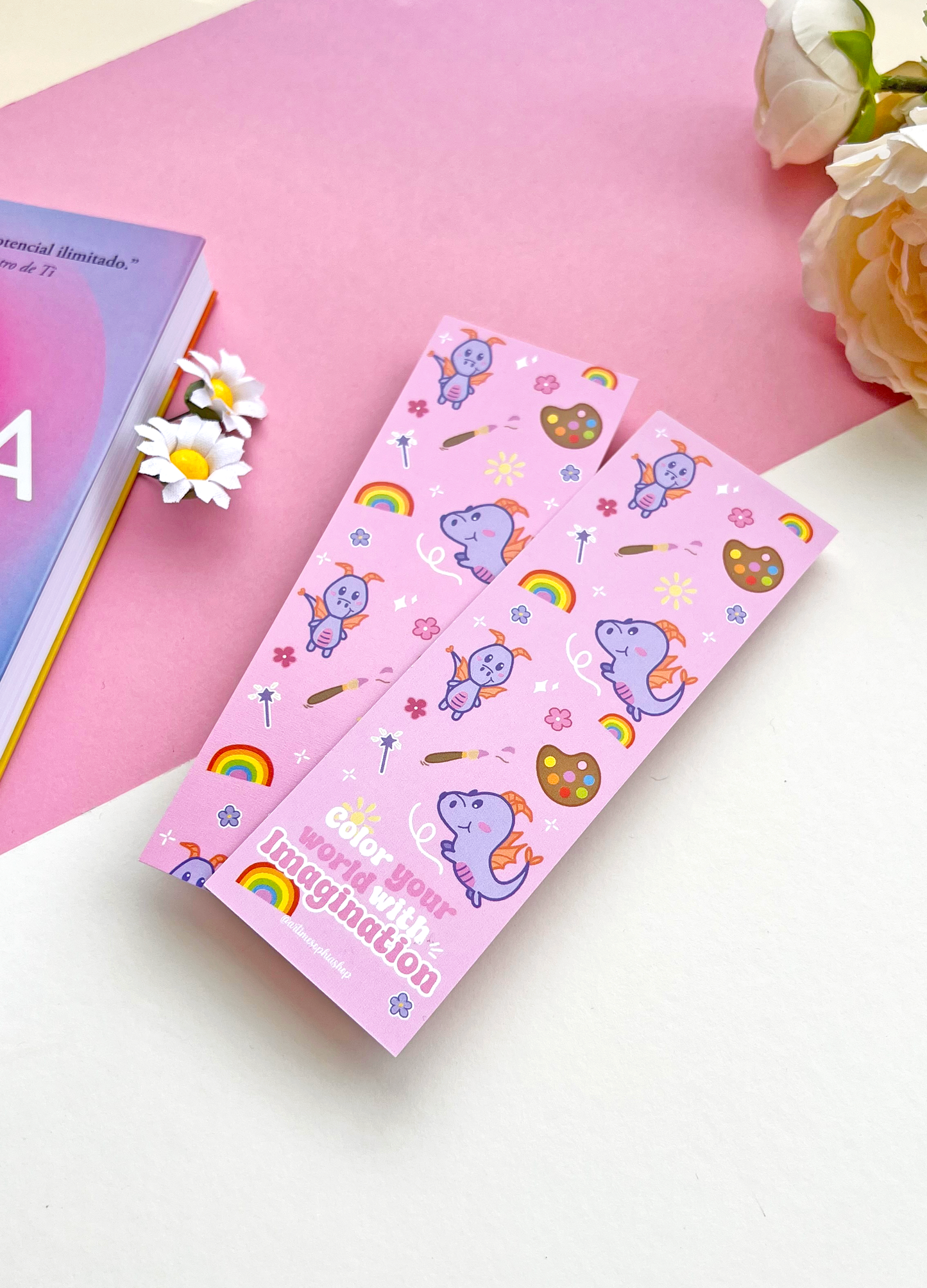 Double-sided lilac and pink bookmark featuring Figment surrounded by flowers, rainbow colors, and art supplies, with the phrase “Color your world with imagination” on the back.