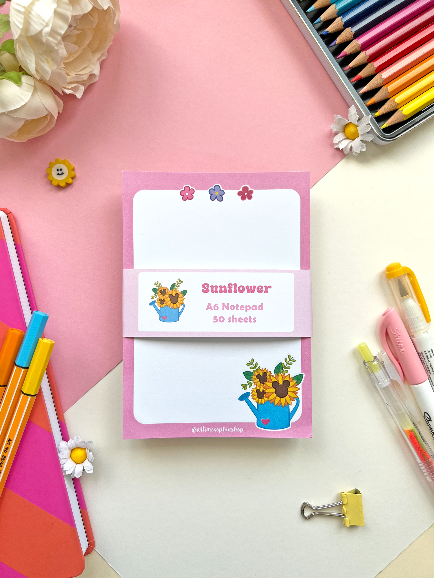 A6 notepad with a soft pink background and a sunflower-filled watering can, paired with the phrase “Give Yourself Time To Bloom” — ideal for notes or journaling.