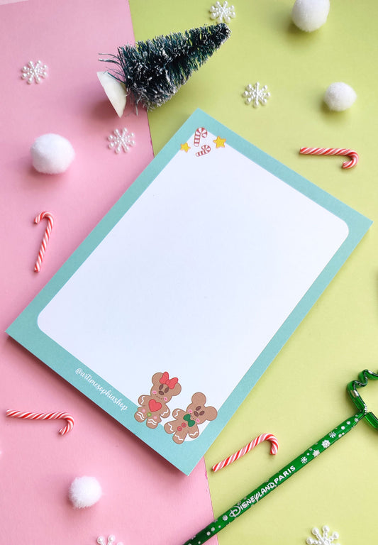 A6 notepad featuring gingerbread-style Mickey and Minnie in a festive holiday setting