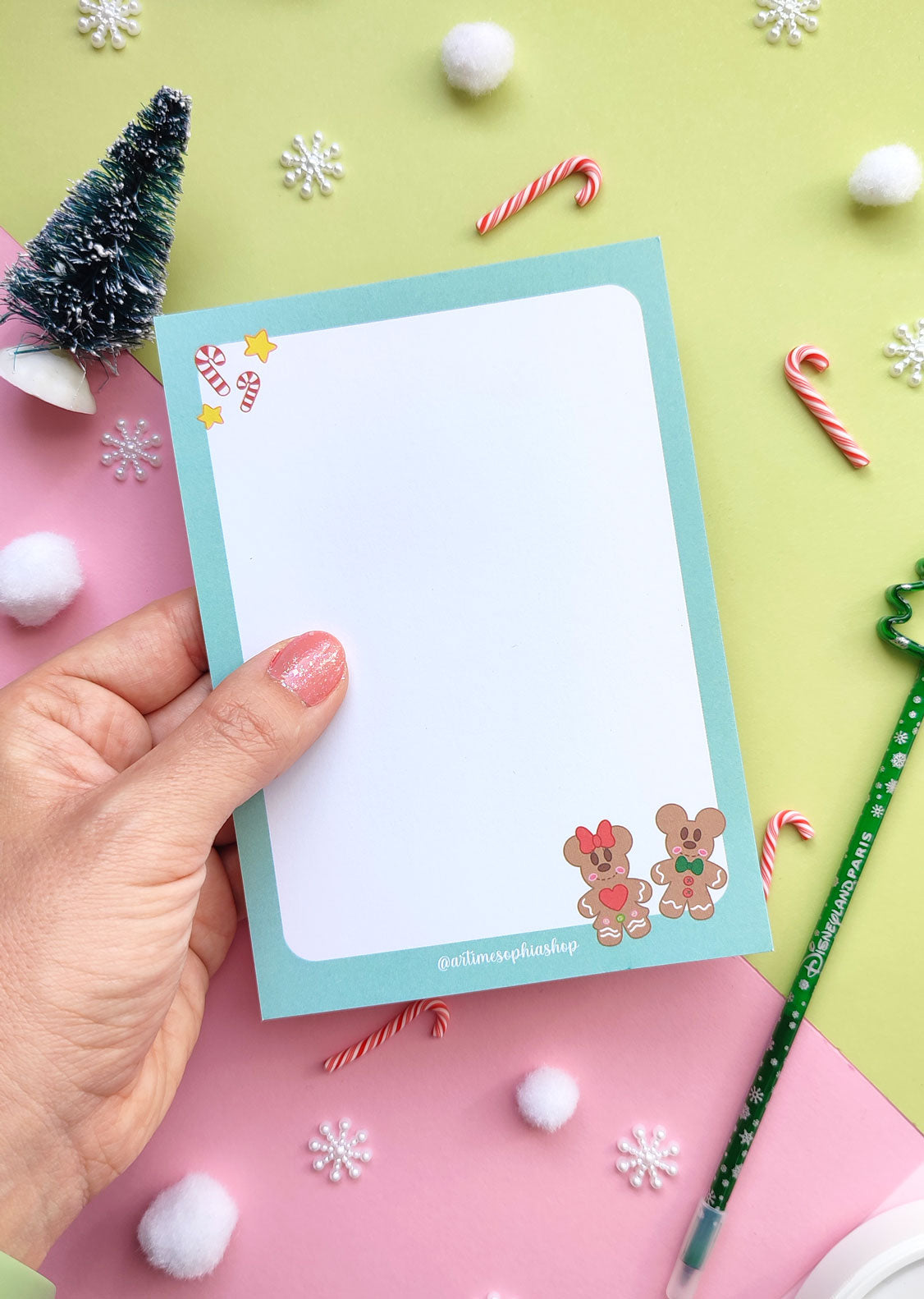 A6 notepad featuring gingerbread-style Mickey and Minnie in a festive holiday setting