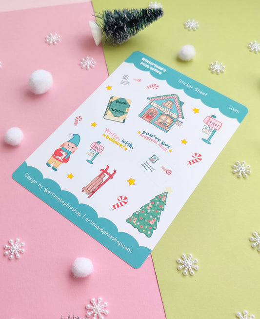 Set of 12 vinyl stickers with matte finish featuring festive illustrations from Winterland, including Elf Ellie, a vintage post office, sleigh, mailbox, and more.