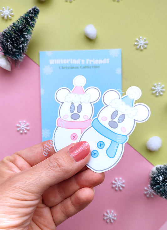 Festive sticker pack featuring snowman-style Mickey and Minnie in cozy winter outfits, printed on vinyl with soft snowy colors and holiday charm.