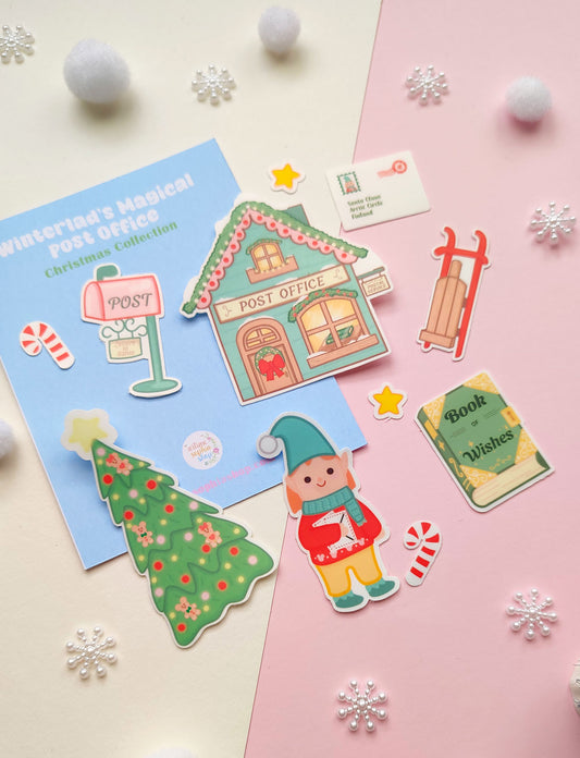 Set of 12 vinyl stickers with matte finish featuring festive illustrations from Winterland, including Elf Ellie, a vintage post office, sleigh, mailbox, and more.
