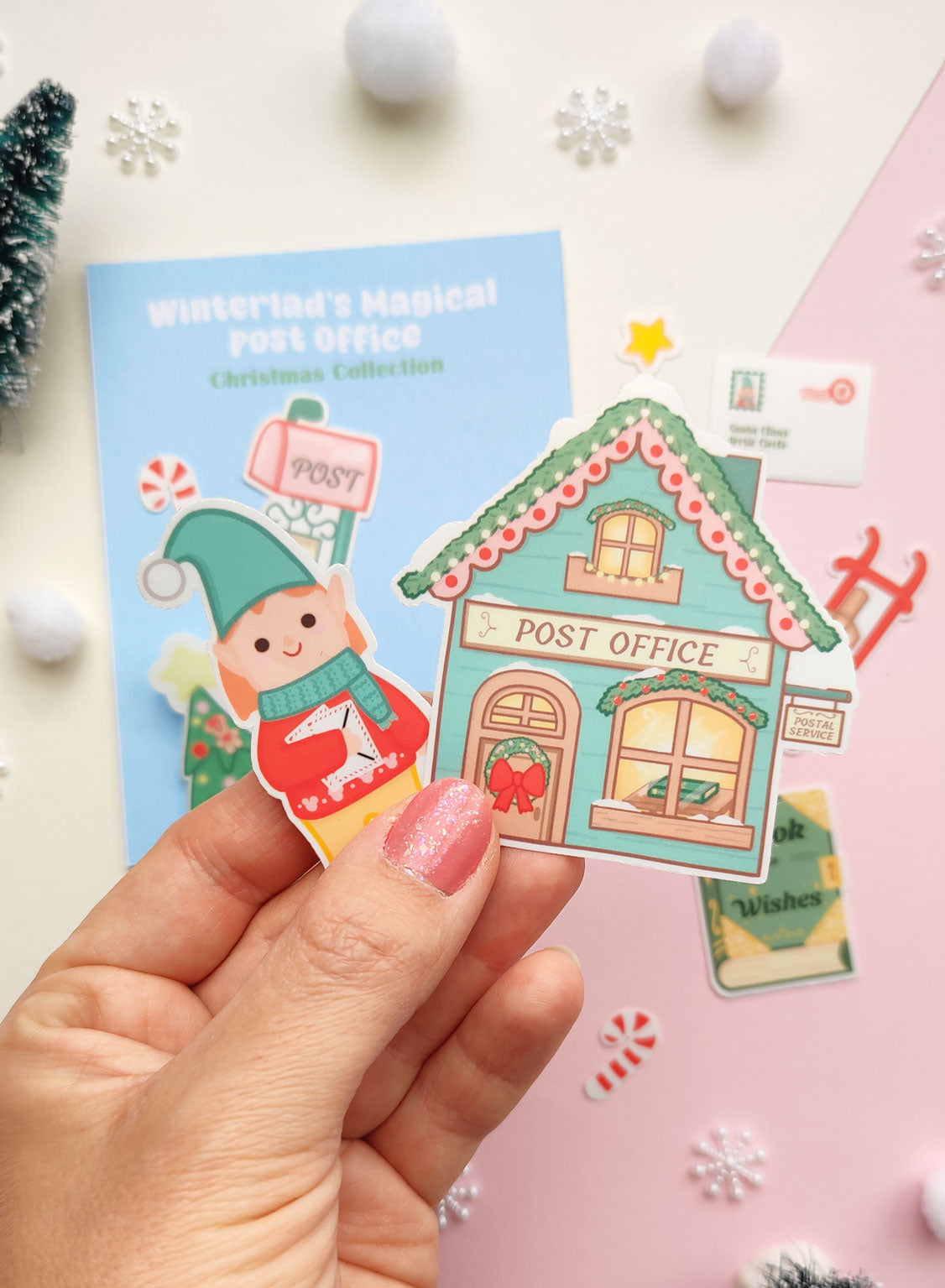 Set of 12 vinyl stickers with matte finish featuring festive illustrations from Winterland, including Elf Ellie, a vintage post office, sleigh, mailbox, and more.