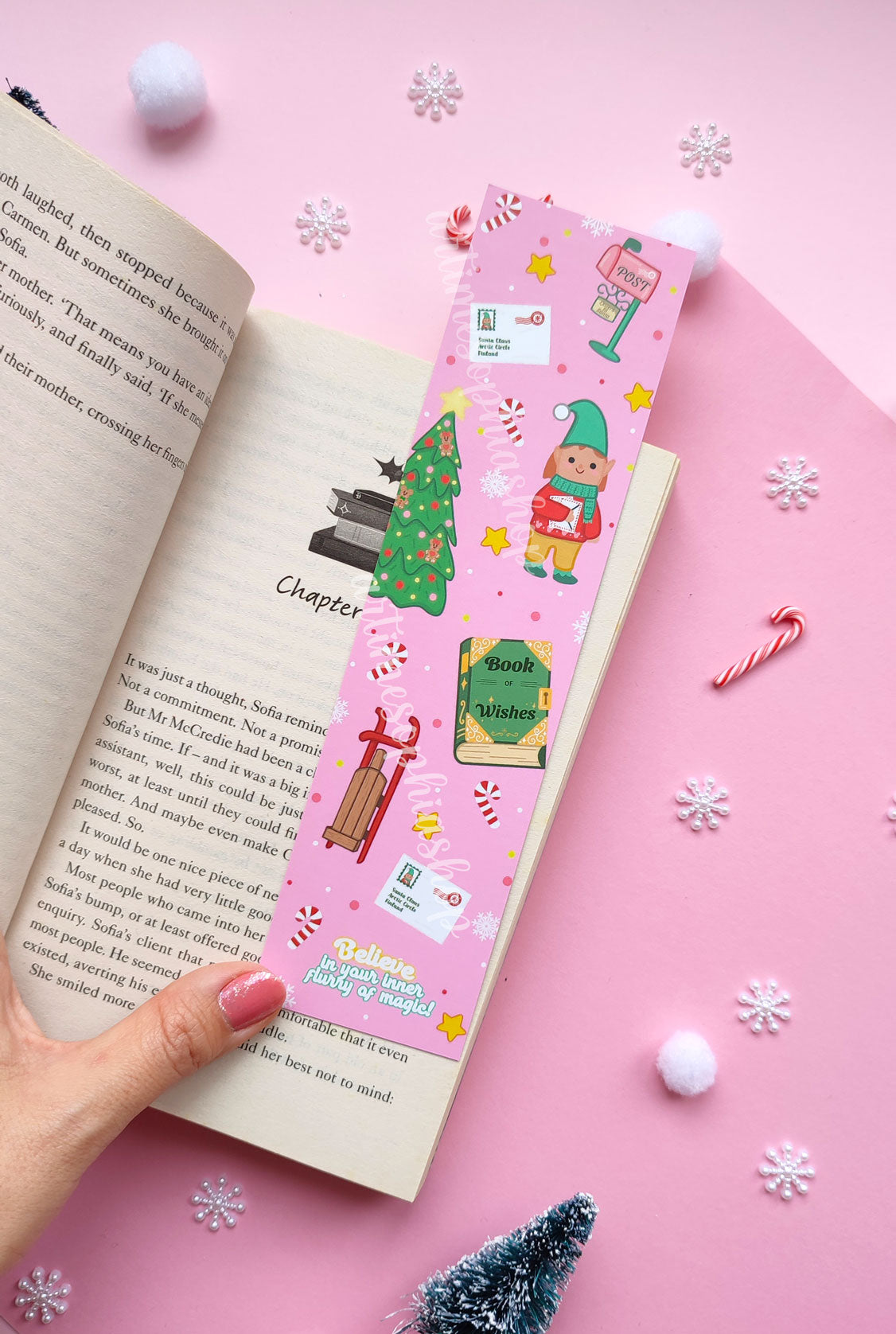 Illustrated Christmas bookmark with Elf Ellie, a vintage post office, and magical details, available in soft pink or cheerful yellow.