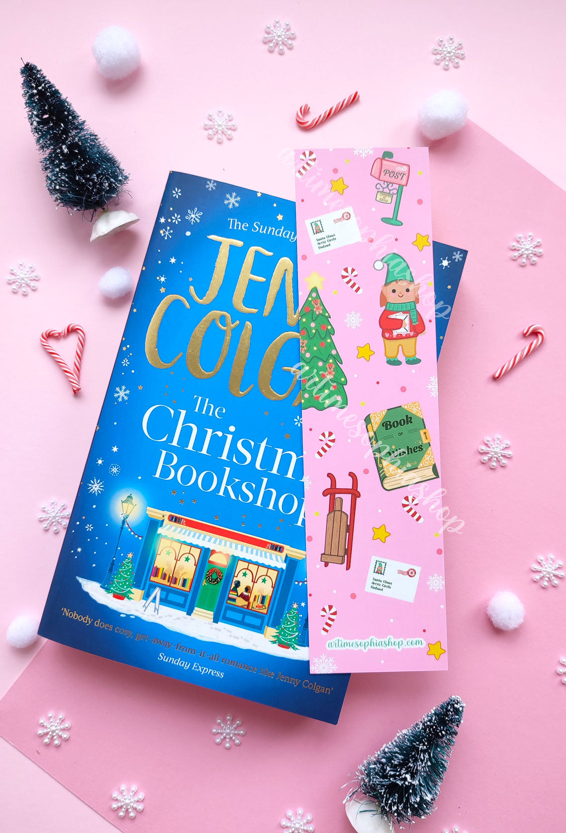 Illustrated Christmas bookmark with Elf Ellie, a vintage post office, and magical details, available in soft pink or cheerful yellow.