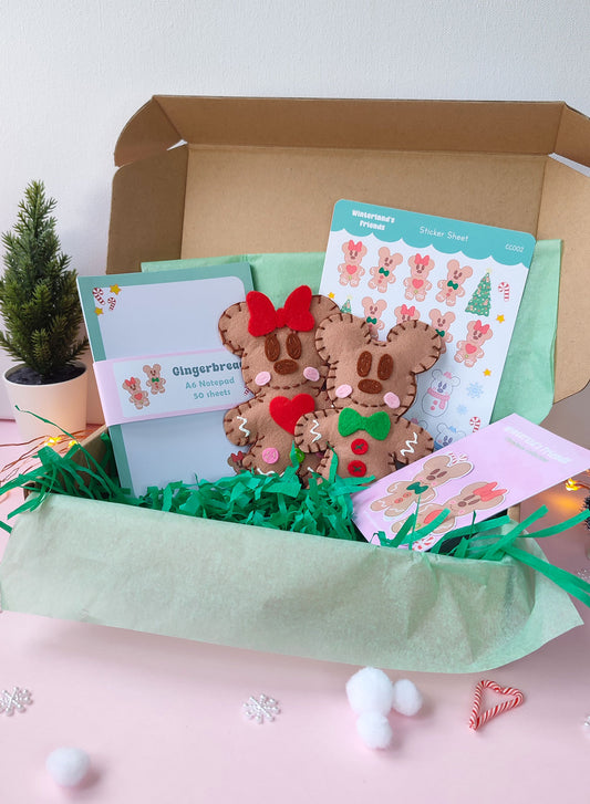 Christmas gift bundle featuring handmade gingerbread Mickey & Minnie ornaments, festive notepad, and holiday sticker packs with Disney-inspired designs