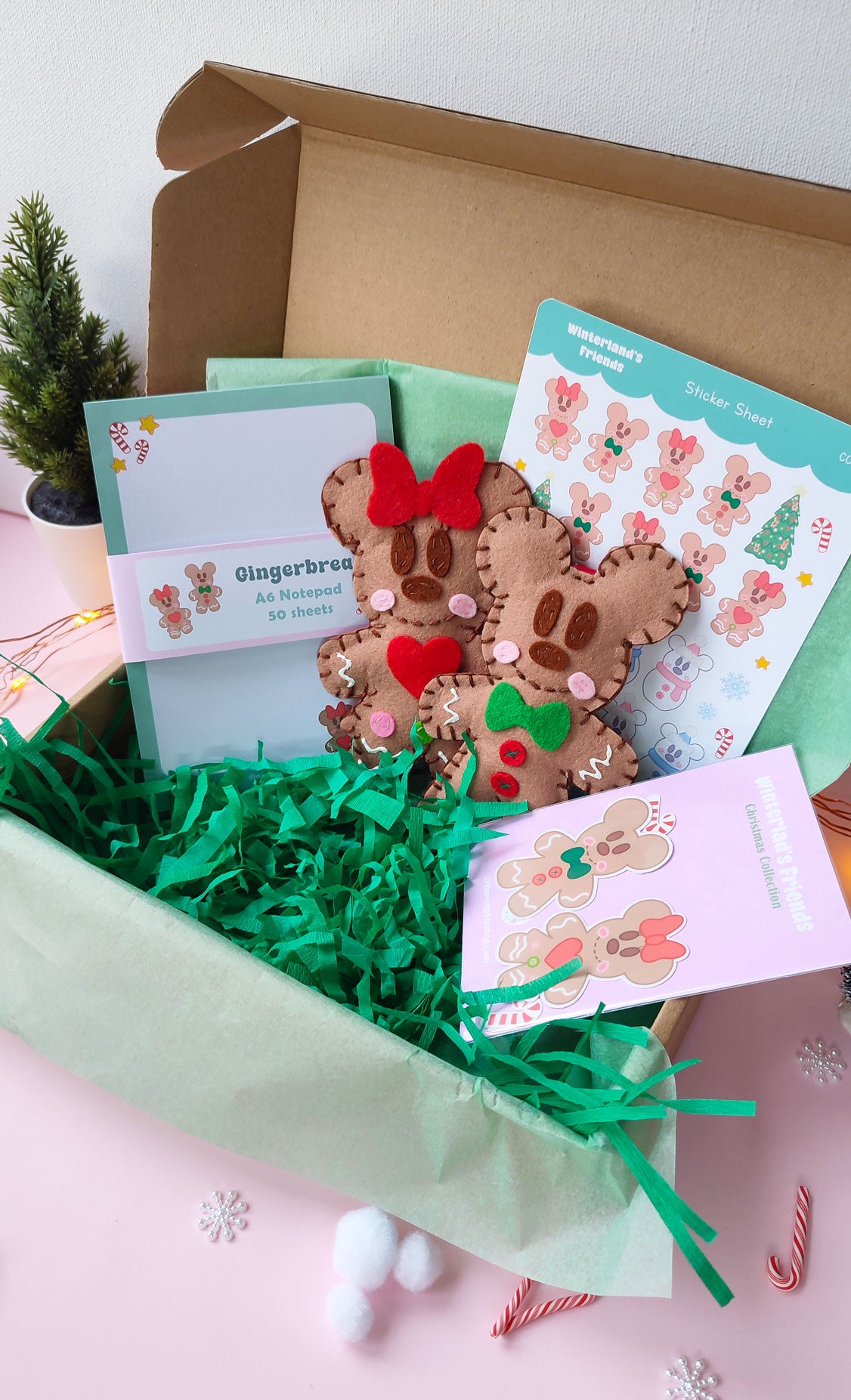 Christmas gift bundle featuring handmade gingerbread Mickey & Minnie ornaments, festive notepad, and holiday sticker packs with Disney-inspired designs