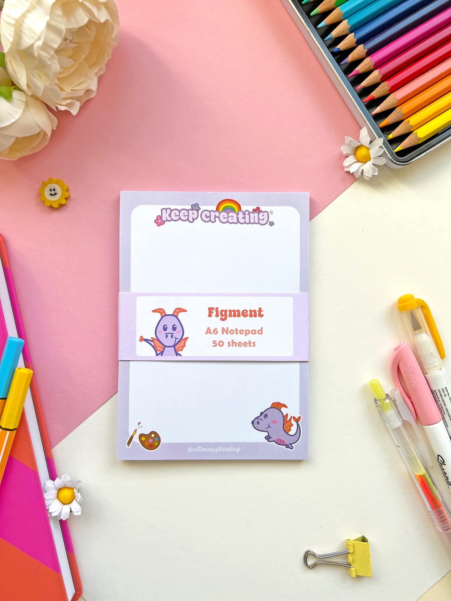 A6 notepad with a pastel purple background featuring Figment surrounded by art-themed doodles and the phrase “Keep Creating” — ideal for creative notes and planning.