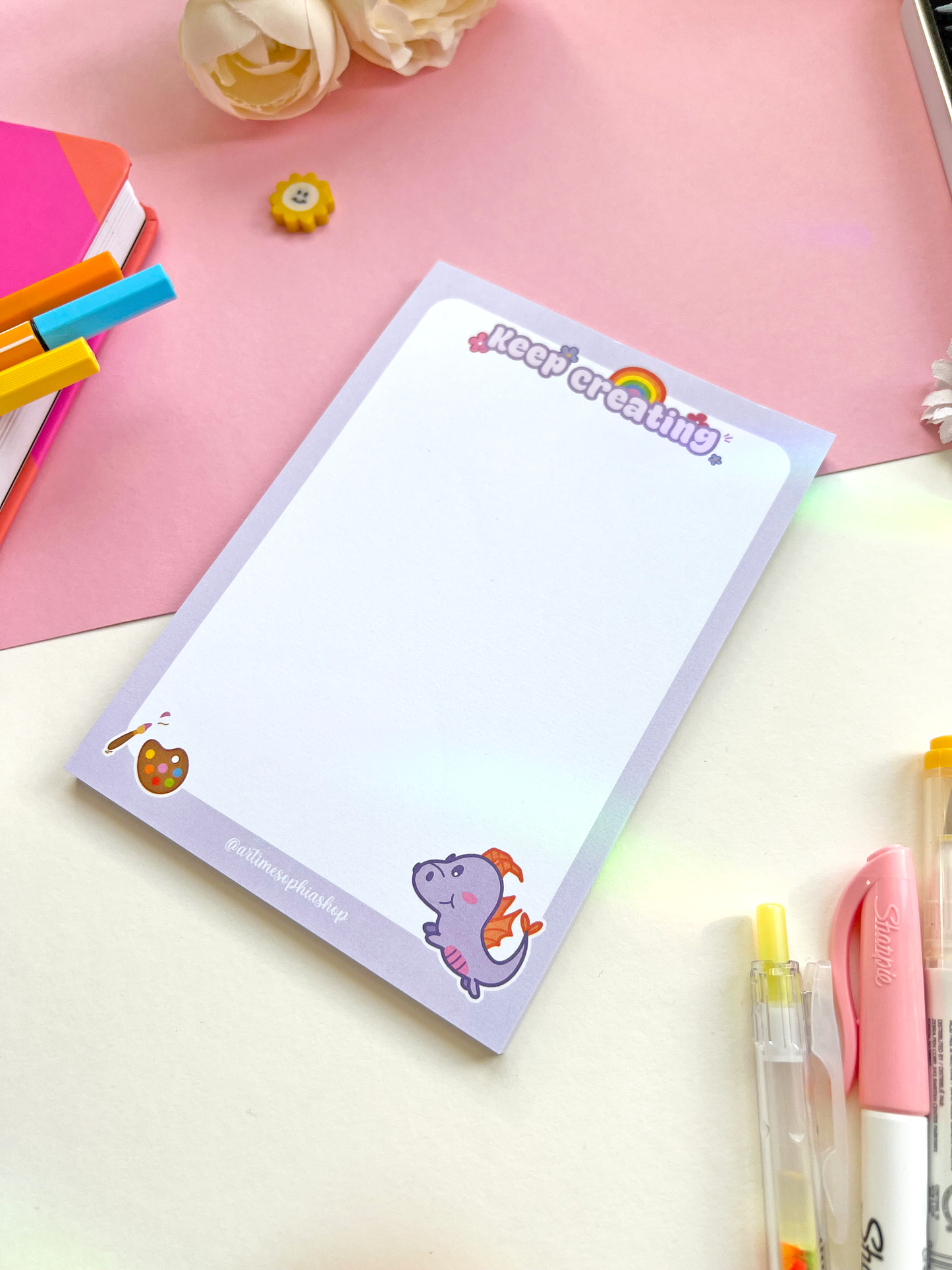 A6 notepad with a pastel purple background featuring Figment surrounded by art-themed doodles and the phrase “Keep Creating” — ideal for creative notes and planning.