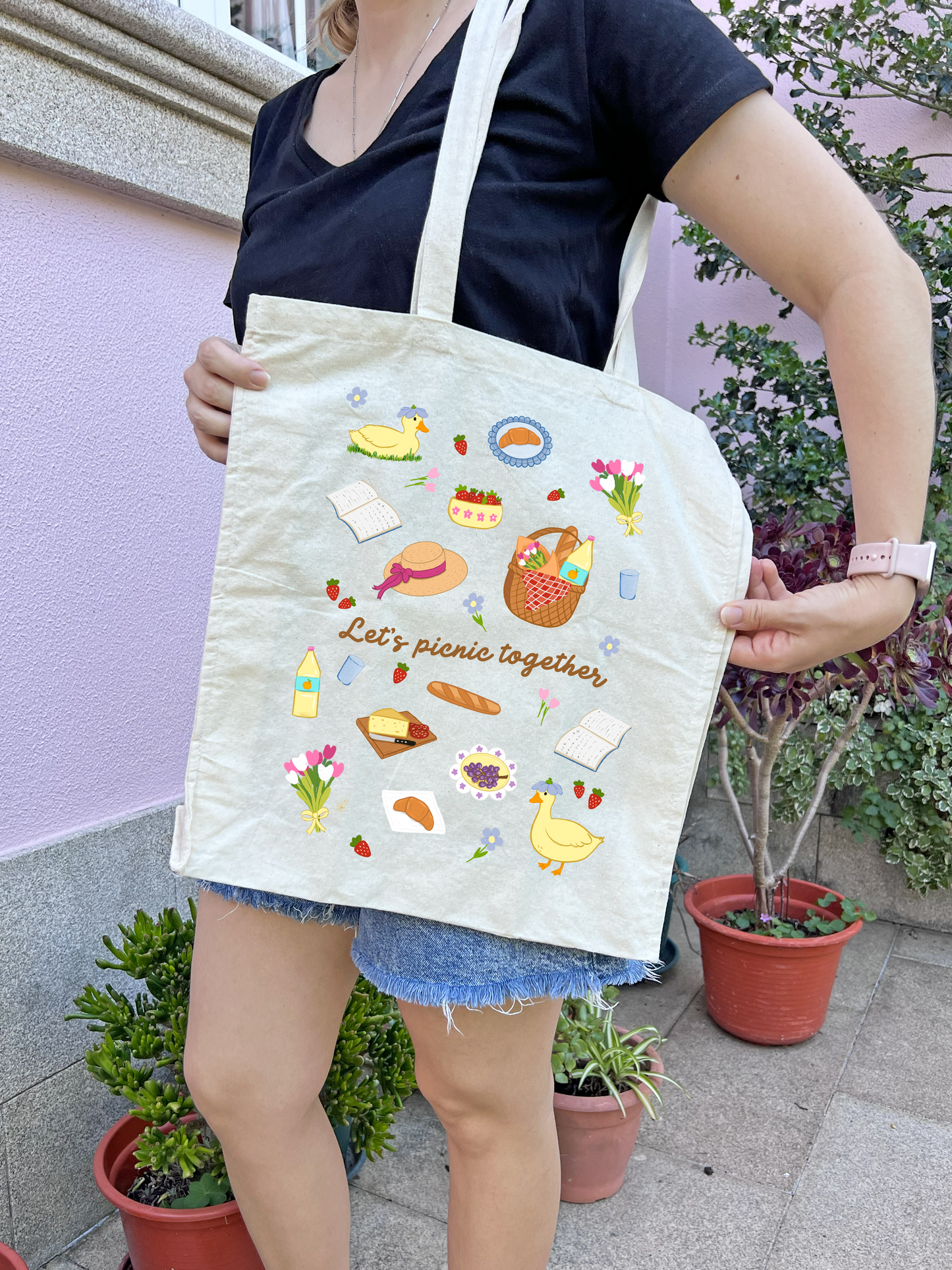 Cotton tote bag featuring whimsical picnic illustrations and floral details