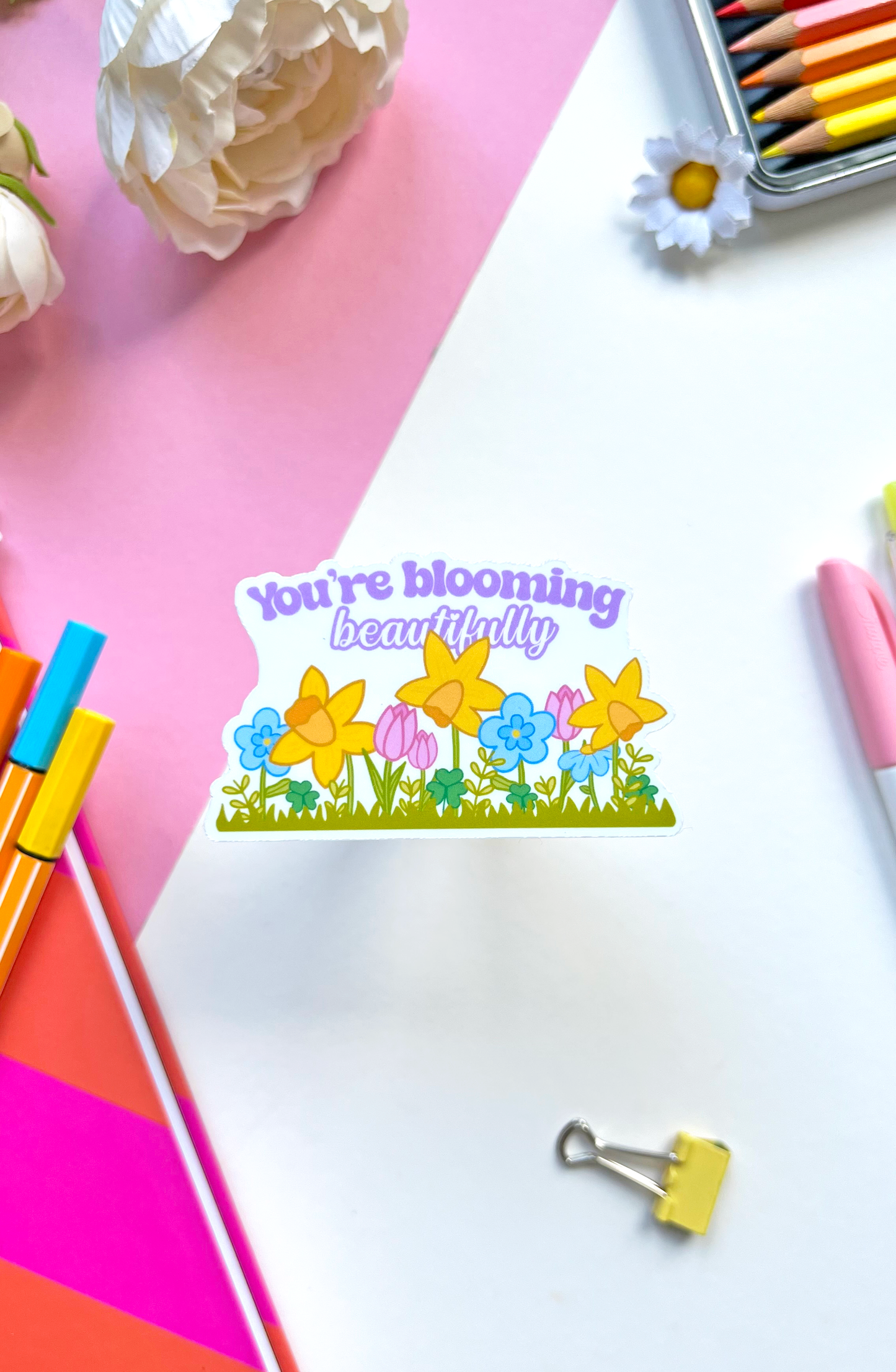 Waterproof vinyl sticker with pastel flowers and the uplifting message “You’re Blooming Beautifully” — perfect for journals, bottles, or laptops.