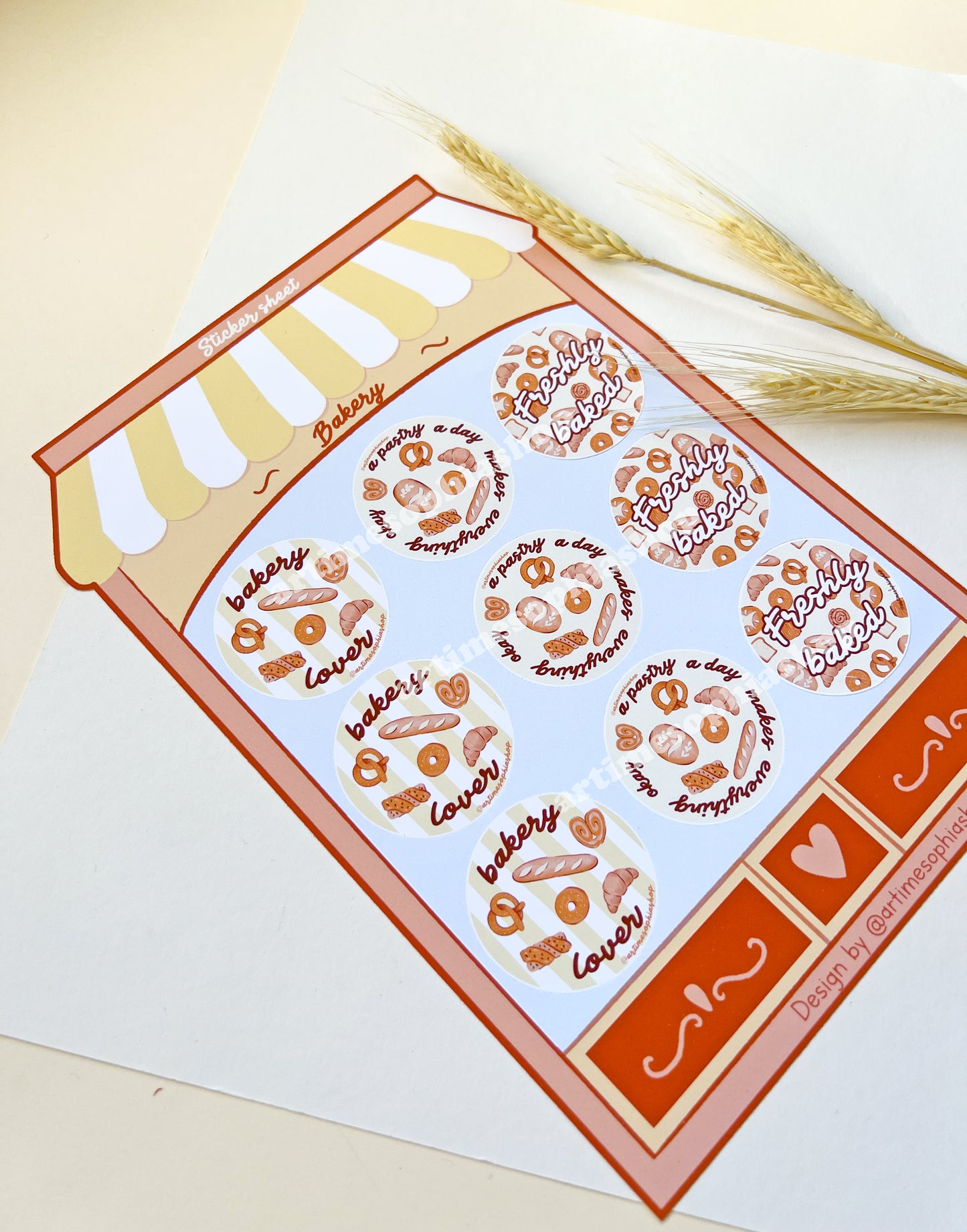 Large bakery-themed sticker sheet designed like a bakery storefront with nine round illustrated labels featuring bakery-inspired phrases.