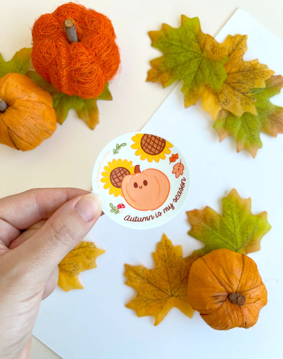 Round Autumn Is My Season sticker featuring a pumpkin, sunflowers, autumn leaves and mushroom