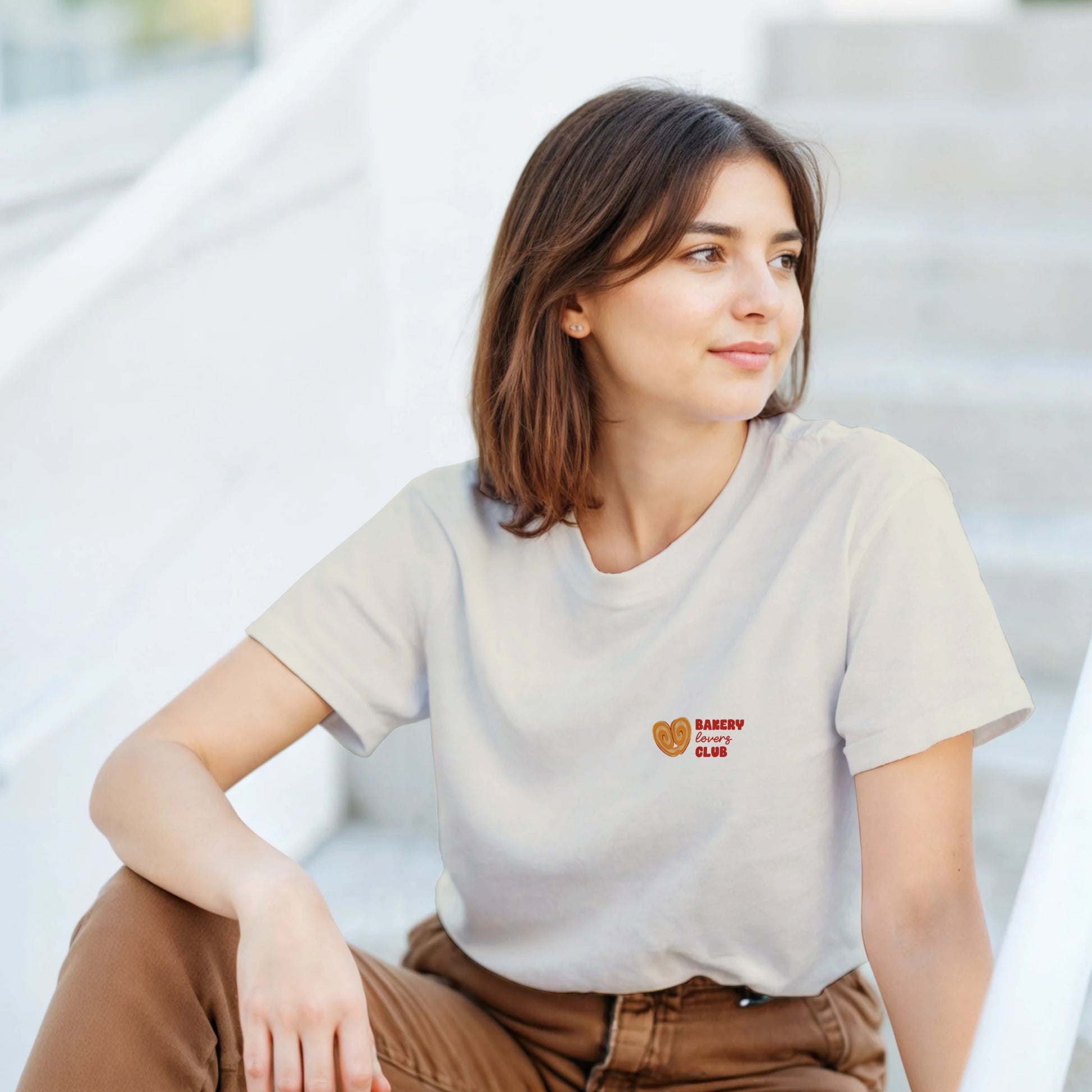 Cream T-shirt with a small Bakery Lovers Club illustration on the front