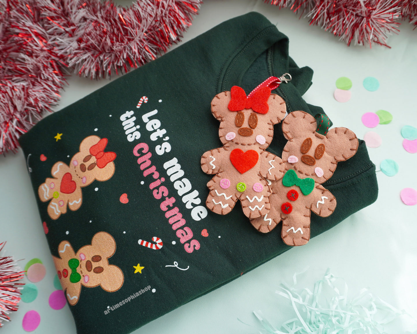 Bring the sweetness of Christmas to life with this cosy and magical Gingerbread Holiday Bundle — a heart-warming set that combines a Disney-inspired sweatshirt with two handmade felt ornaments of Mickey and Minnie as gingerbread cookies