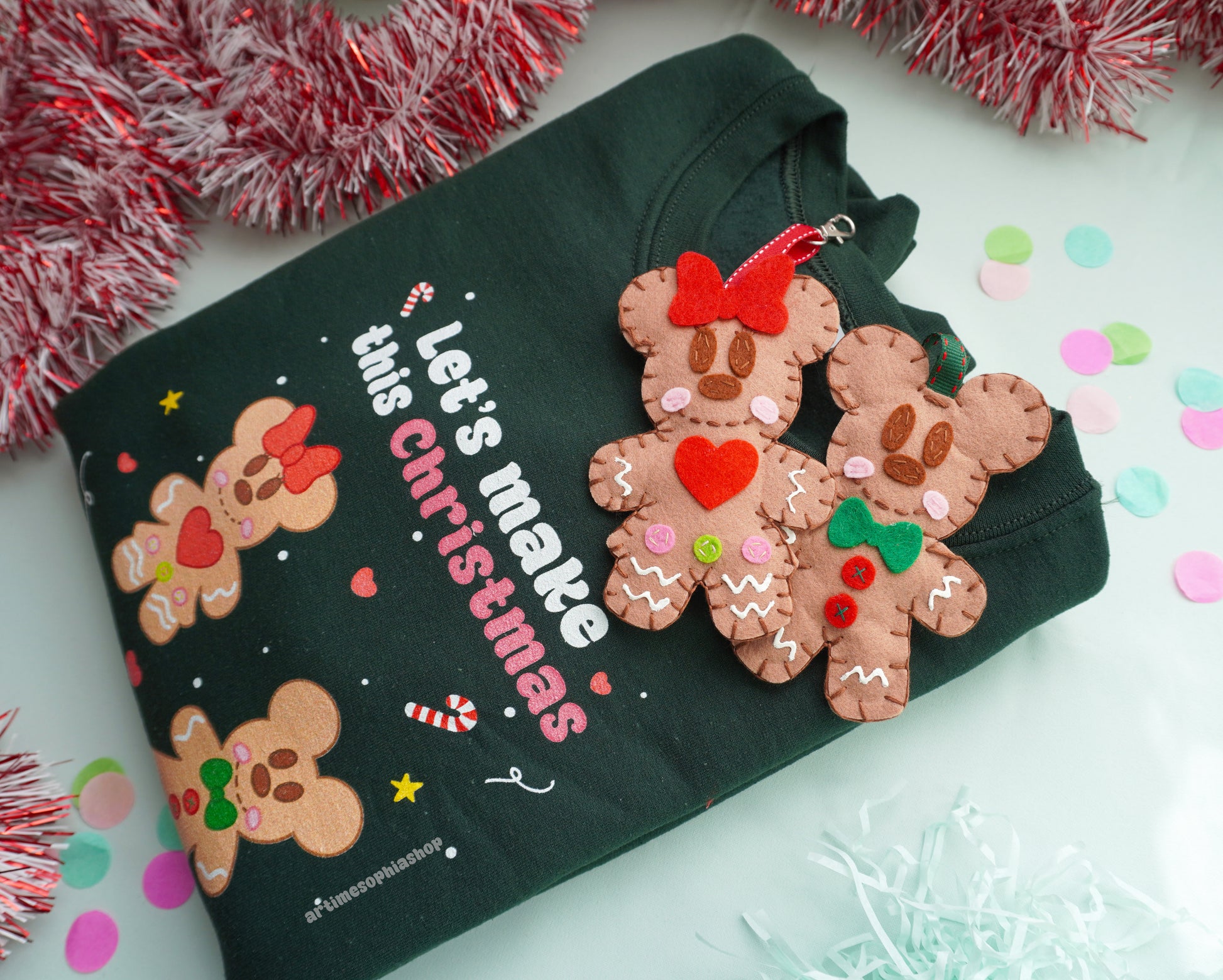 Bring the sweetness of Christmas to life with this cosy and magical Gingerbread Holiday Bundle — a heart-warming set that combines a Disney-inspired sweatshirt with two handmade felt ornaments of Mickey and Minnie as gingerbread cookies