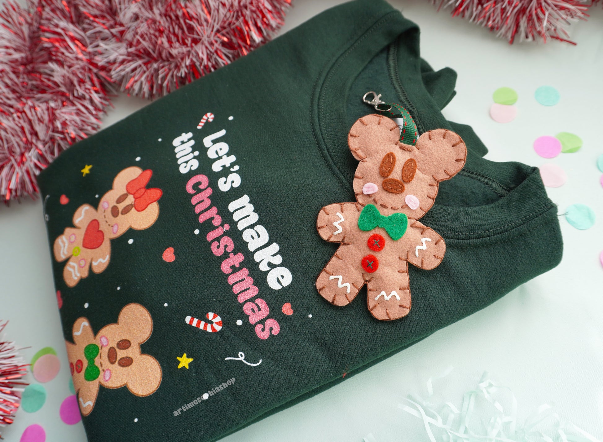 Bring the sweetness of Christmas to life with this cosy and magical Gingerbread Holiday Bundle — a heart-warming set that combines a Disney-inspired sweatshirt with two handmade felt ornaments of Mickey and Minnie as gingerbread cookies