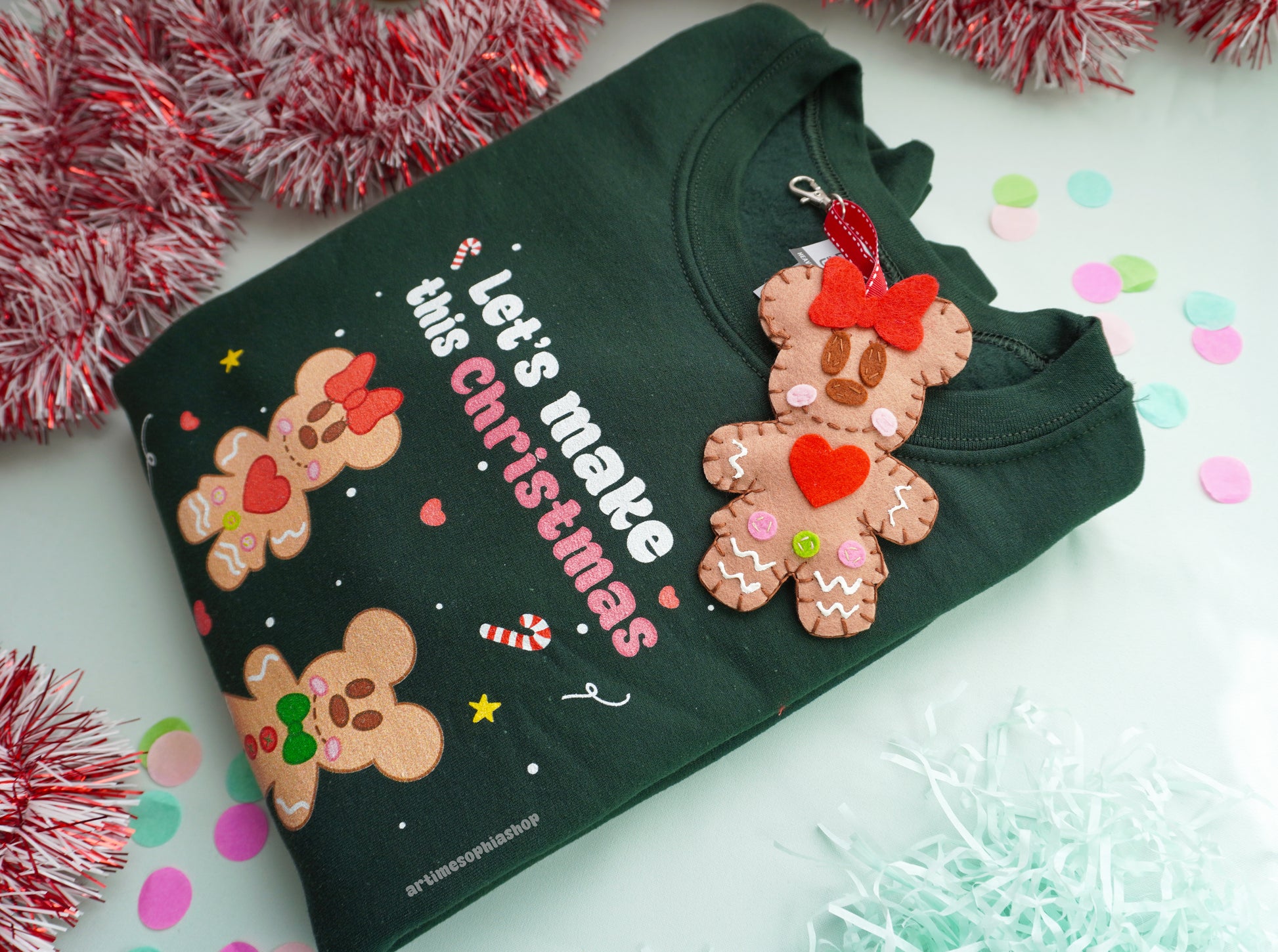 Bring the sweetness of Christmas to life with this cosy and magical Gingerbread Holiday Bundle — a heart-warming set that combines a Disney-inspired sweatshirt with two handmade felt ornaments of Mickey and Minnie as gingerbread cookies