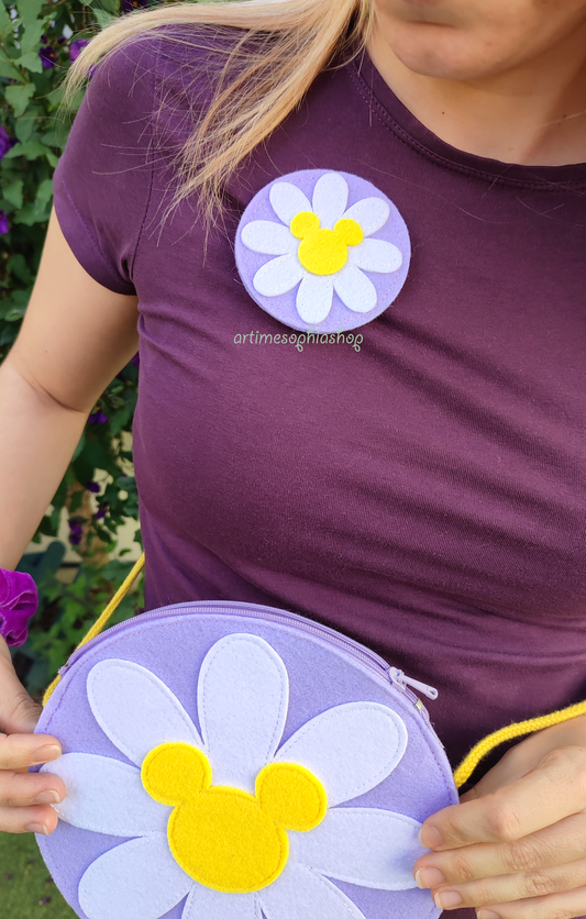 Handmade felt Daisy flower with Mickey-shaped center on a lilac base. Customisable accessory for Disney Bounds — use as a magnet, hairclip, keychain, or pin.