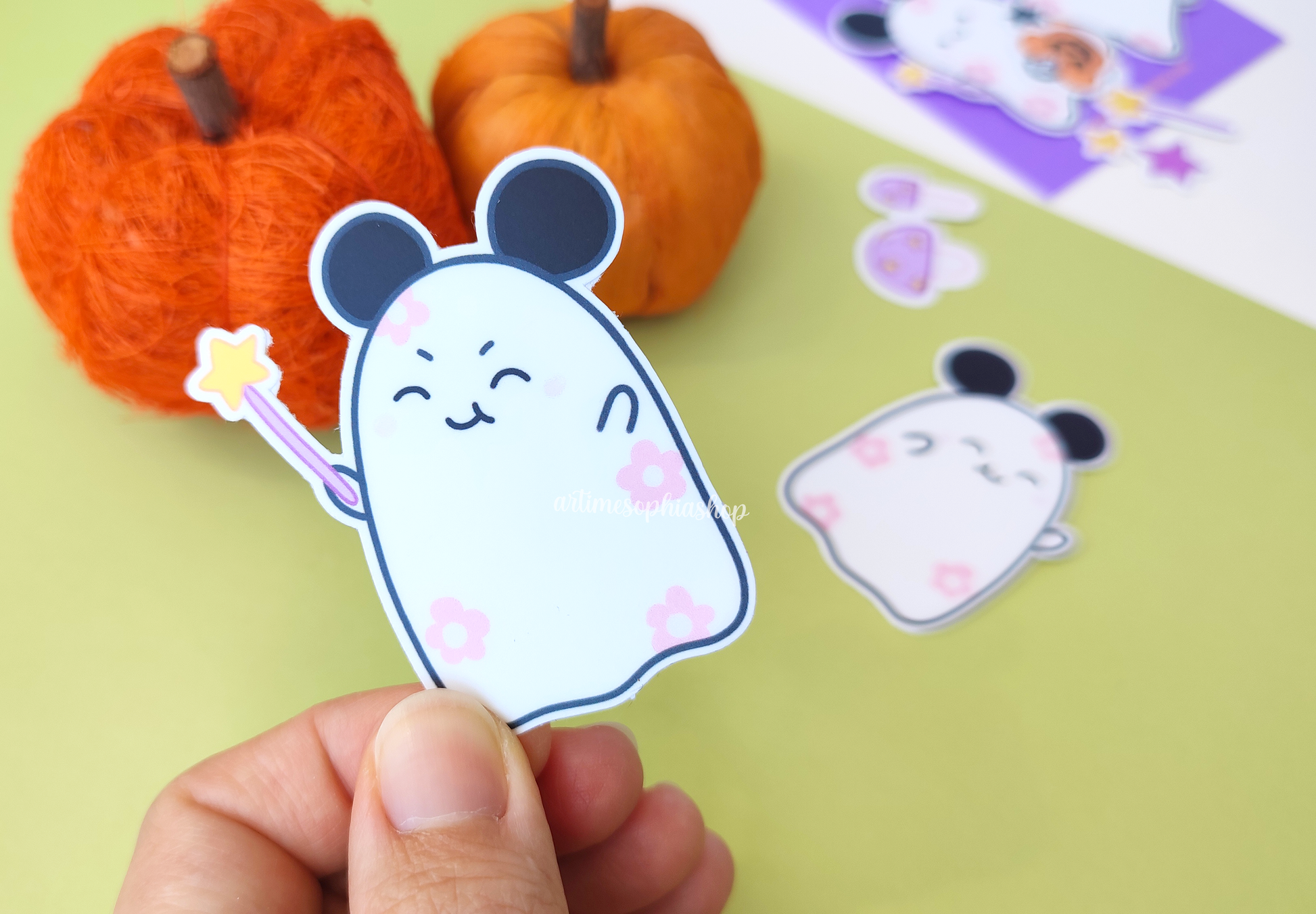 Halloween sticker pack with 14 hand-drawn vinyl stickers featuring Daisyboo the ghost and Pip the bat, printed in a spooky-cute pastel style.