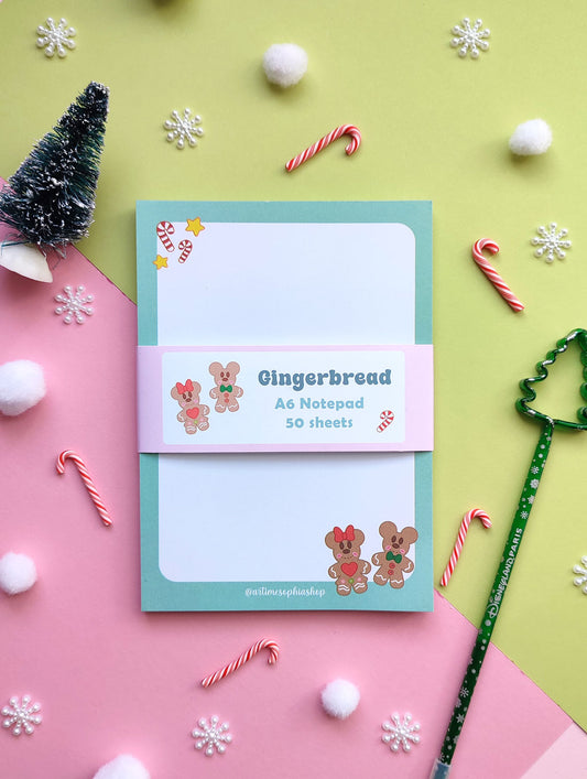 A6 notepad featuring gingerbread-style Mickey and Minnie in a festive holiday setting