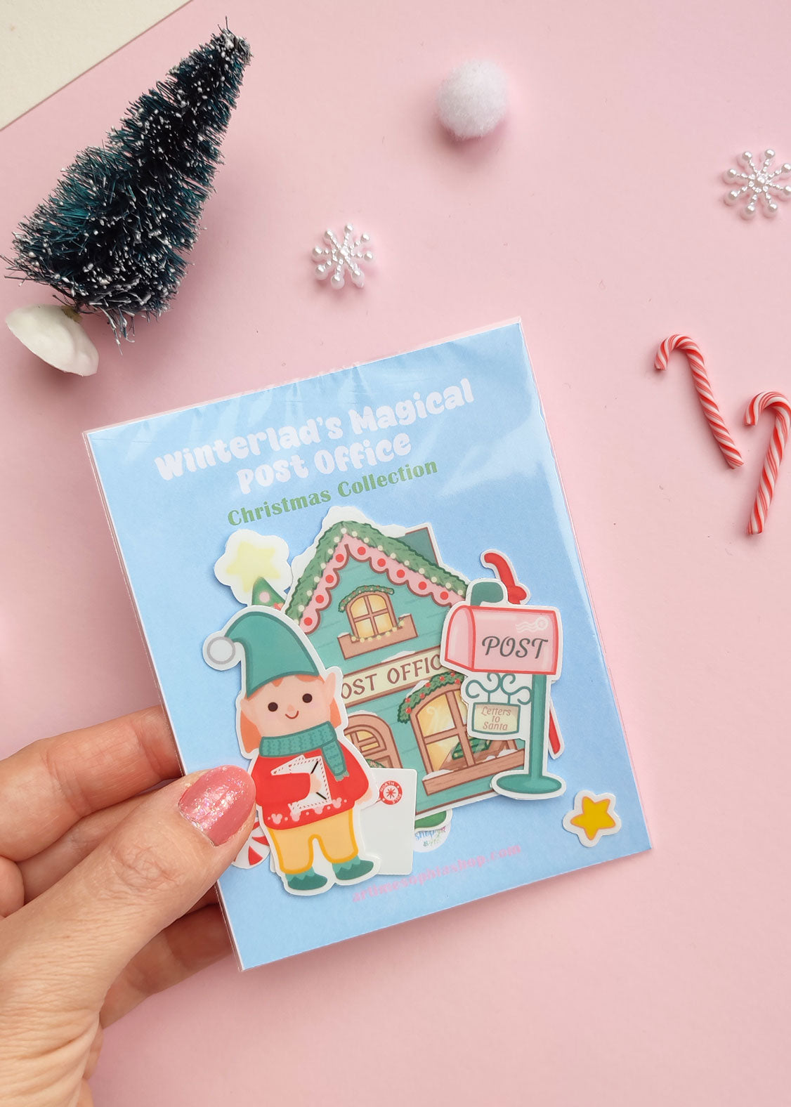 Set of 12 vinyl stickers with matte finish featuring festive illustrations from Winterland, including Elf Ellie, a vintage post office, sleigh, mailbox, and more.