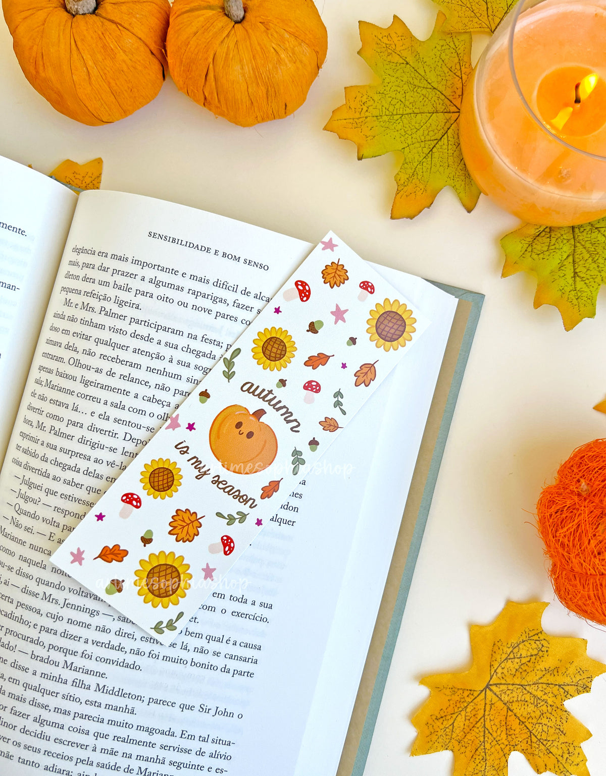 Autumn Is My Season bookmark styled inside a book with a cosy autumn setting