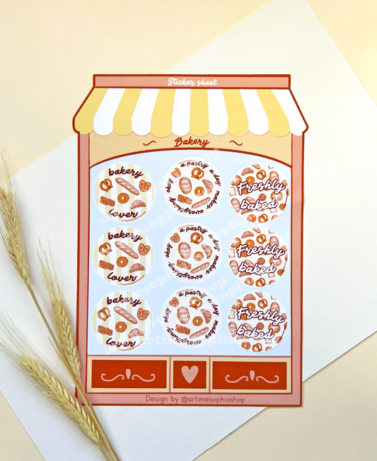 Large bakery-themed sticker sheet designed like a bakery storefront with nine round illustrated labels featuring bakery-inspired phrases.