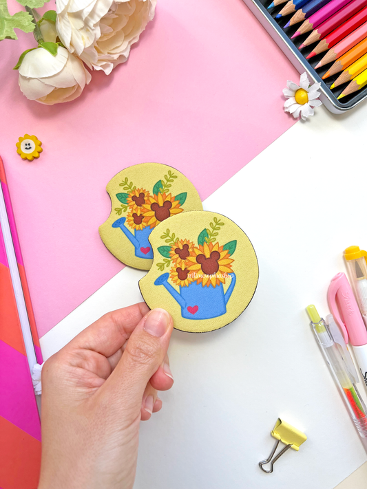 Set of two round sunflower car coasters with bright yellow petals and hidden Mickey details, made of neoprene for a clean and colorful car interior.