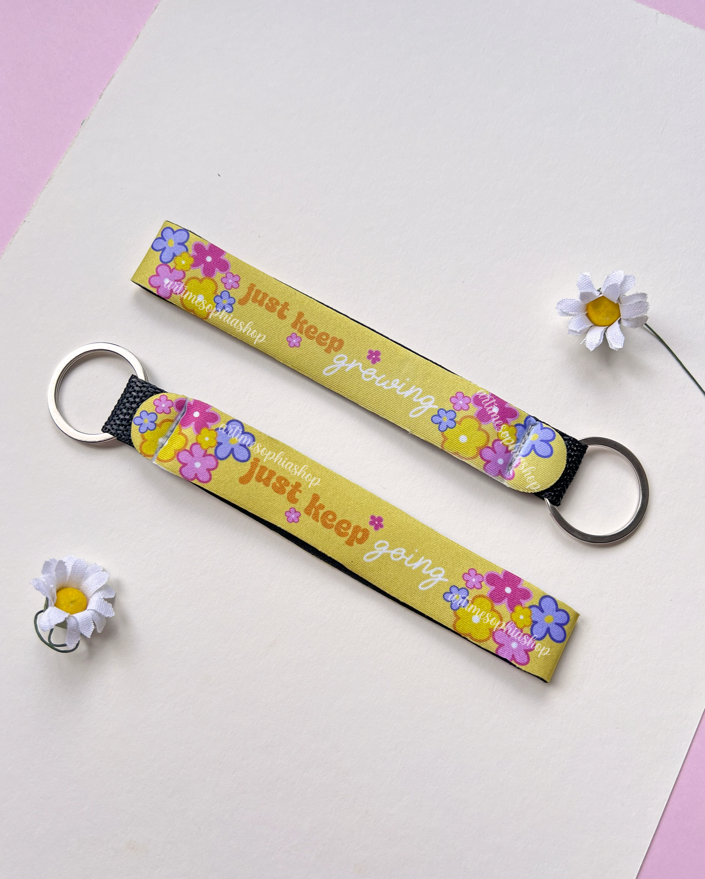Flat lay of yellow floral keychain with flowers detail