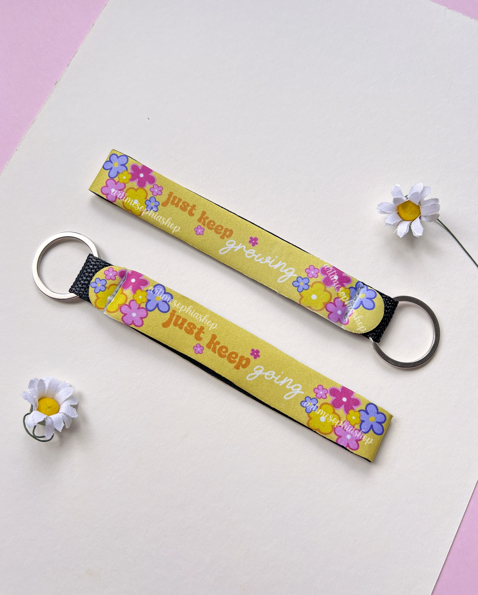 Flat lay of yellow floral keychain with flowers detail